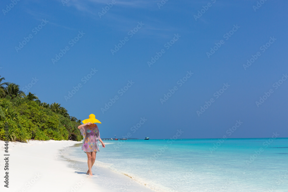 appy woman in summer hat walking on beautiful beach, travel card