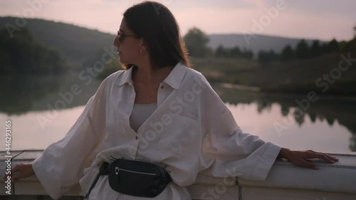 pretty woman is enjoying summer vacation, portrait at nature at sunset time