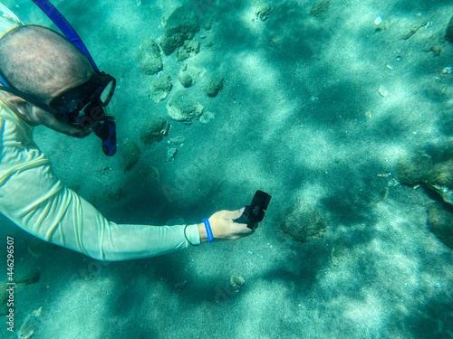 snorkeling on peanut island taking video with camera 