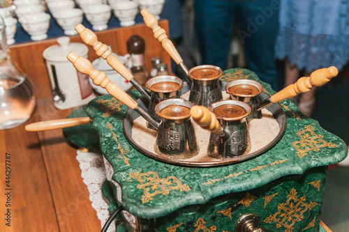 Turkish coffee brewed on sand in cezve. Oriental, east coffee photo