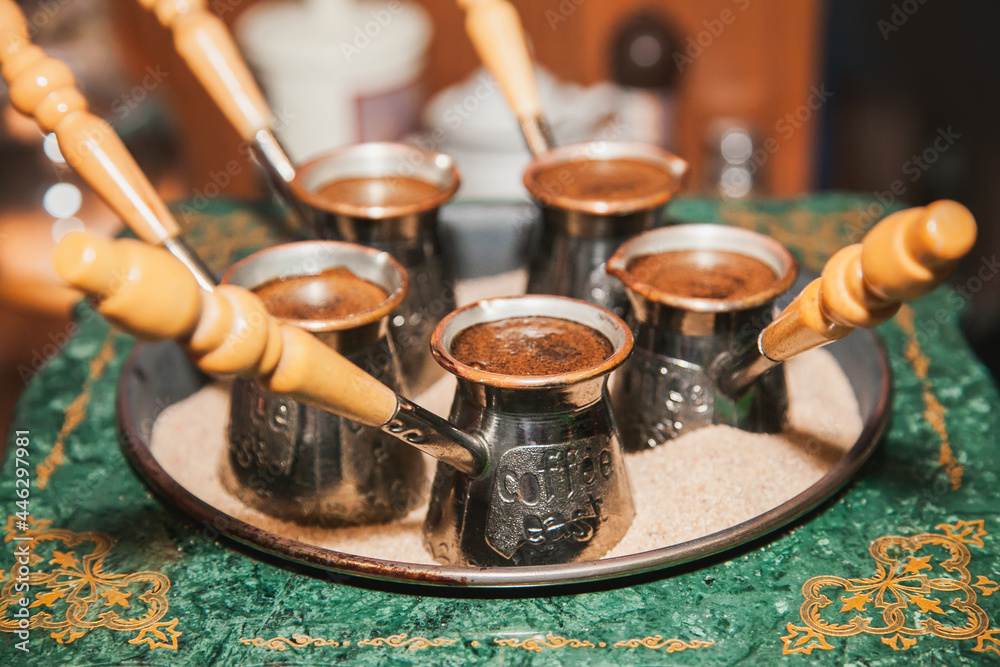 Turkish coffee brewed on sand in cezve. Oriental, east coffee