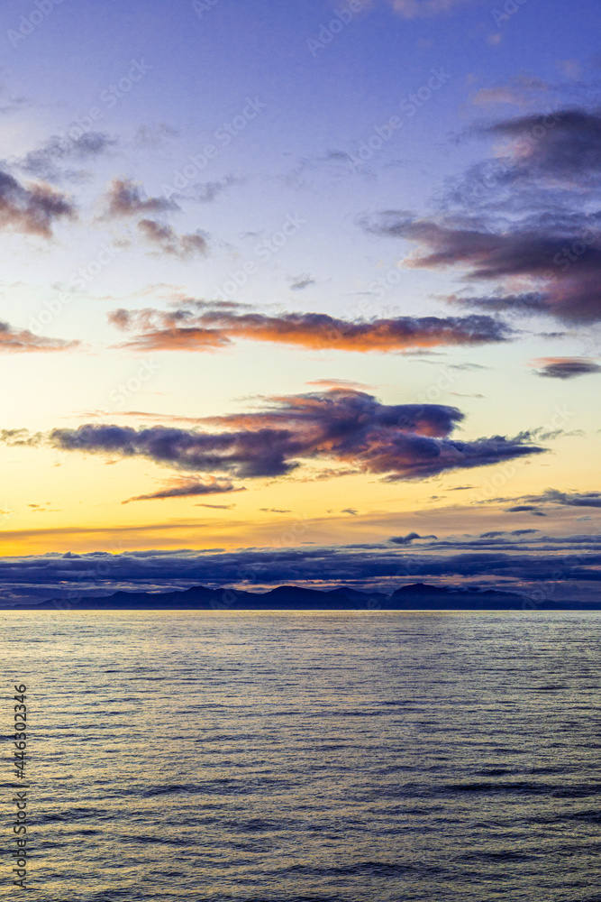 A strange shape of a flying figure or an angel in a sunset over the NW Pacific coast near Prince of Wales Island, Alaska, USA - Viewed from a cruise ship sailing the Inside Passage