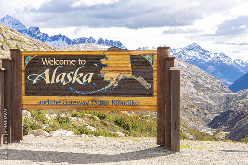 Welcome to Alaska sign in early June on the Canada/USA border beside the Klondike Highway NE of Skagway, Alaska, USA