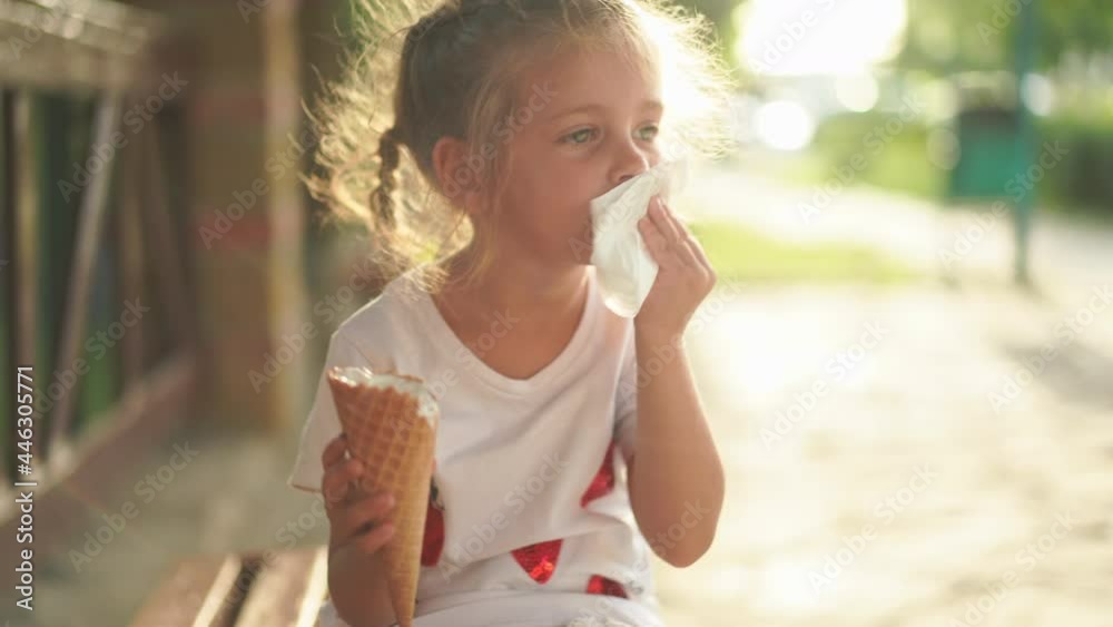 Little girl eat ice cream outdoor. Caucasian female child enjoy while lick white ice cream in waffle cone Summer mood dressed white dress . High quality 4k footage Little girl eat ice cream outdoor. Caucasian female child enjoy while lick white ice cream in waffle cone Summer mood dressed white dress . High quality 4k footage