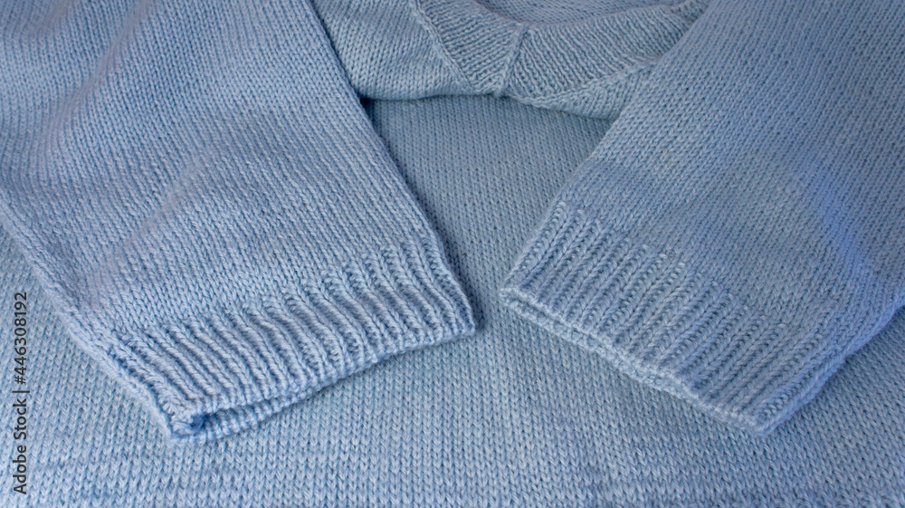 Pullover made of blue wool yarn. Handmade work. Merino wool. Needlework. Handmade work. Hobby. Pullover made of blue wool yarn. Handmade work. Merino wool. Needlework. Handmade work. Hobby.