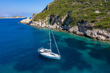 yacht in azure transparent sea. Aerial view of sailboat