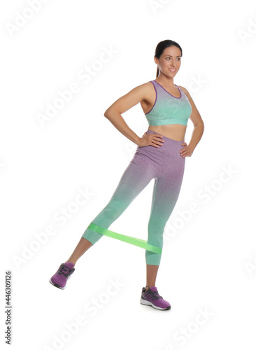 Woman doing sportive exercise with fitness elastic band on white background © New Africa