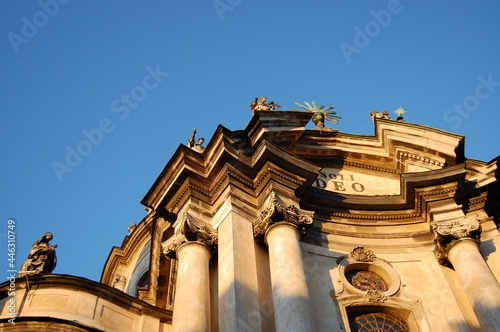 Dominican Church central facade at summer sunset on clear sky. Architecture of old Lviv city in Ukraine. Bottom view of the inscription - Soli Deo