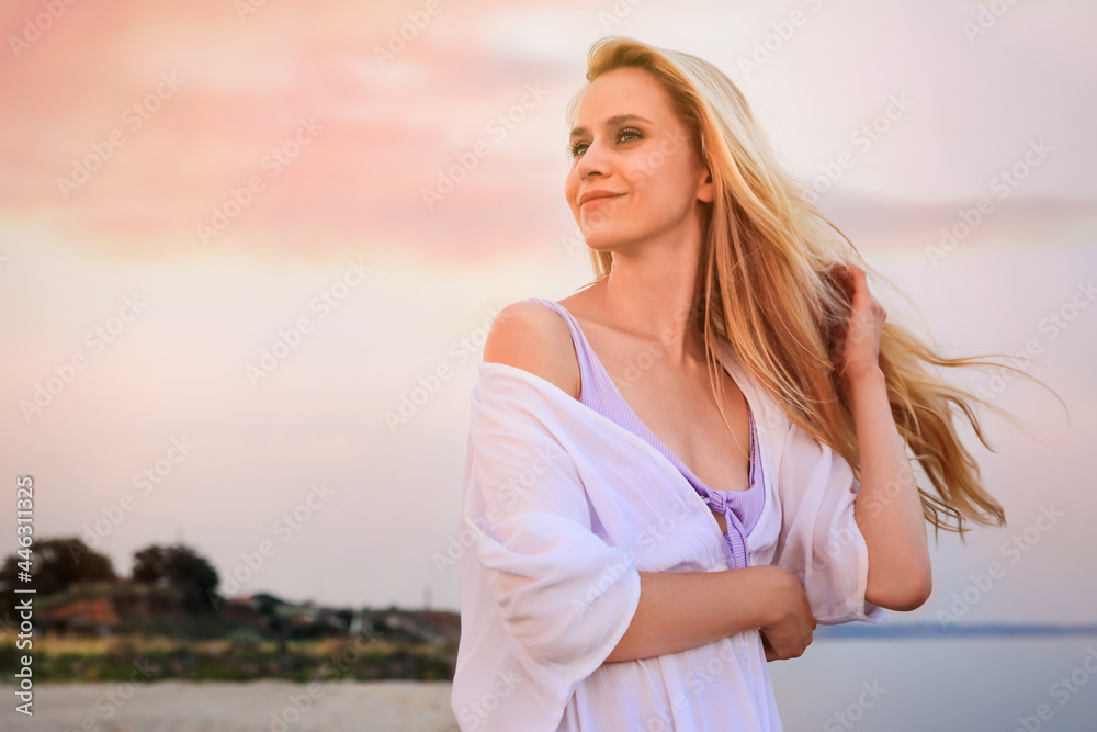 Beautiful young woman on beach in evening, space for text Beautiful young woman on beach in evening, space for text