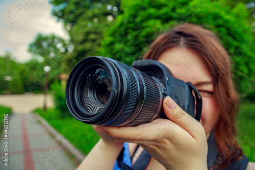 Young girl shooting outdoors using DSLR