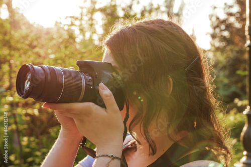 Young girl shooting outdoors using DSLR