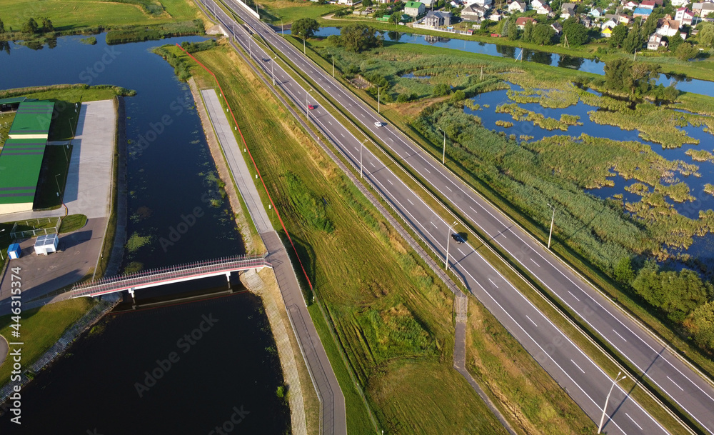 Aerial view of highway road and green meadows and fields Aerial view of highway road and green meadows and fields