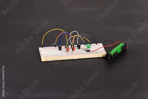 Breadboard with electrical elements, multivibrator circuit. photo