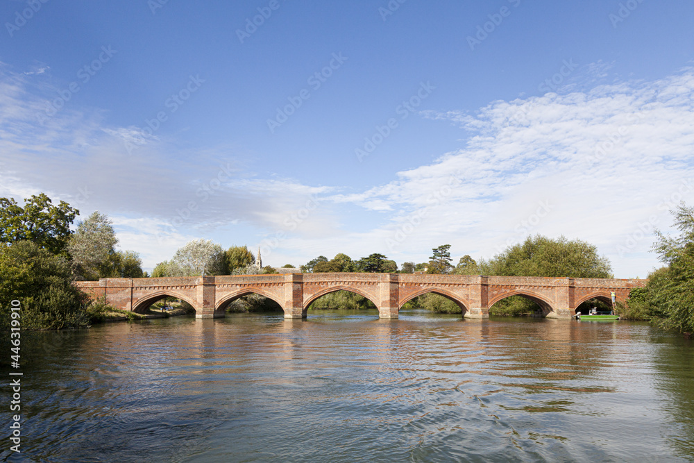 The brick bridge built by Sir Gilbert Scott in 1864 over the River Thames at Clifton Hampden, Oxfordshire, UK