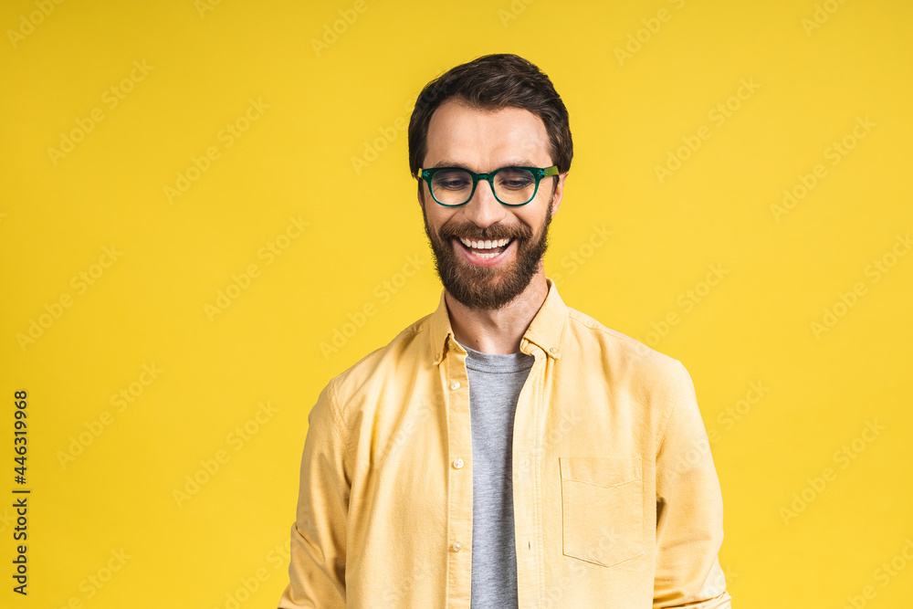 Happy young man. Portrait of handsome young bearded man in casual smiling while isolated over yellow background. Happy young man. Portrait of handsome young bearded man in casual smiling while isolated over yellow background.
