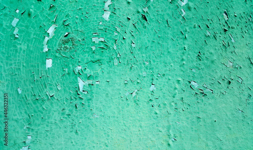 Texture of painted metallic wall cracked from time
