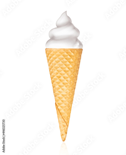 Vanilla soft serve ice cream in wafer cone close-up, isolated on white background