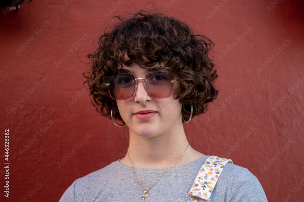 Retrato de joven con el pelo rizado y gafas de sol grandes en distintas ...