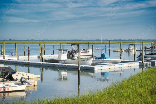 Sea Isle City, New Jersey- Dock with multiple boats on the bay with pleasant cloud coverage