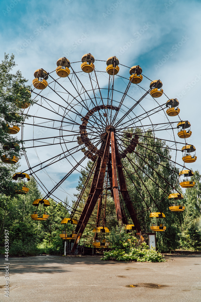 Vertical view of an abandoned ferris wheel in the decaying amusement park of Pripyat, Ukraine inside the Chernobyl Exclusion Zone