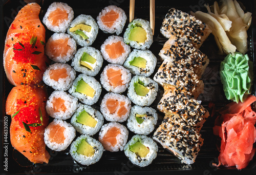 Set with rolls and sushi on a stand. Sushi with raw salmon and red caviar.