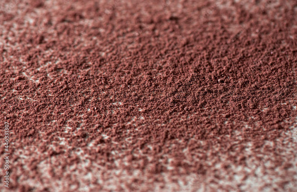 Loosed dry cosmetic pink background pigment. Top view of cracked blush, bronzer, powder or eye shadow cosmetic products. White background, selective focus Loosed dry cosmetic pink background pigment. Top view of cracked blush, bronzer, powder or eye shadow cosmetic products. White background, selective focus