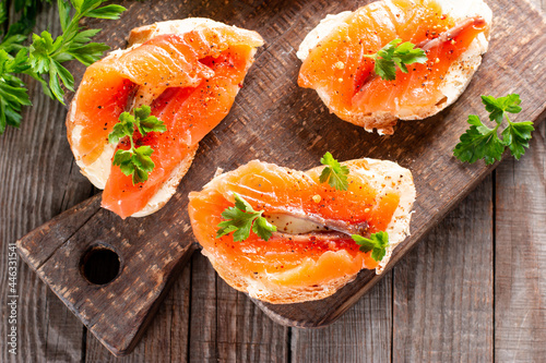 Slices of fresh baguette with butter and salmon