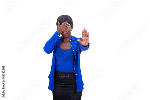 mature businesswoman covering eyes with one hand and the other hand making a stop gesture. © vystekimages