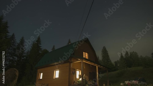 House in the mountains against the background of the starry sky, beautiful time lapse in the Carpathian