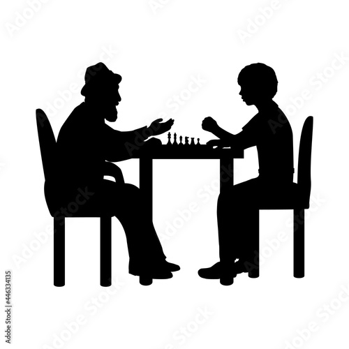Silhouettes boy and grandfather playing chess.