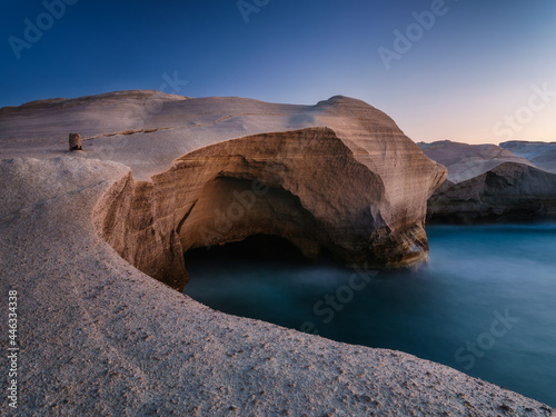 A seascape during sunset. Long exposure. Rocks on the seashore. Sunlight duri...