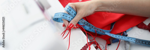 The seamstress holds samples for sewing product photo