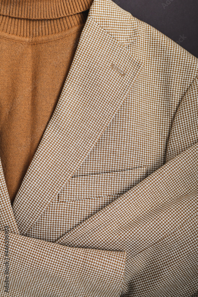 Men outwear flat lay close up, fashionable mens brown sweater combined with light beige blazer on. Men outwear flat lay close up, fashionable mens brown sweater combined with light beige blazer on.