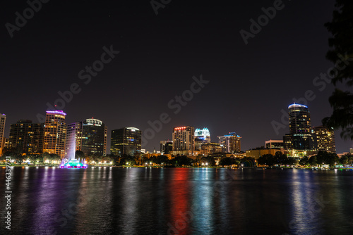 night skyline of downtown orlando with a lake in foreground