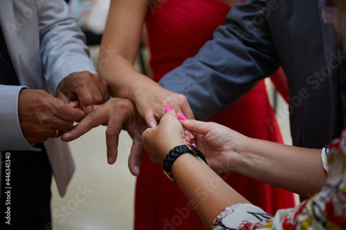 Close up of hands groom and bride wearing a ring