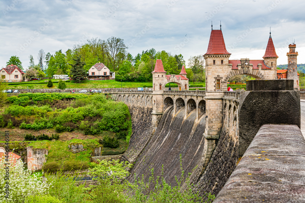Czech republic, Talsperre Les Kralovstvi (Forest Kingdom) - May 15, 2021. Historic hydraulic water dam with orange water in river Elbe