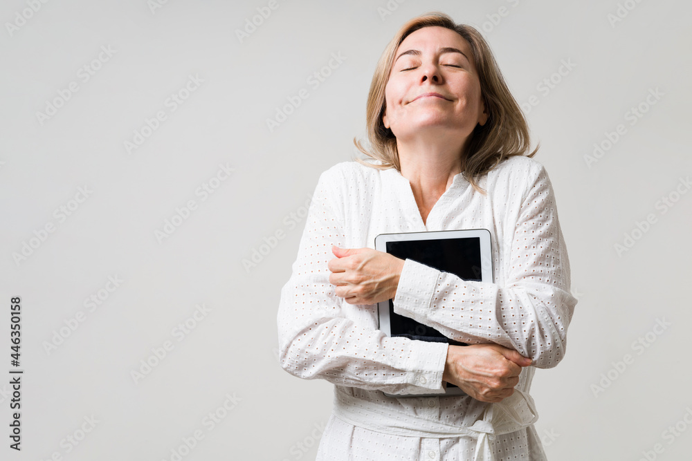 Middle aged woman loving her new tablet Middle aged woman loving her new tablet