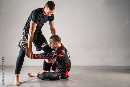 Brazilian jiu jistu bjj no-gi grappling training two male athletes drilling technique sit-up guard copy space photo