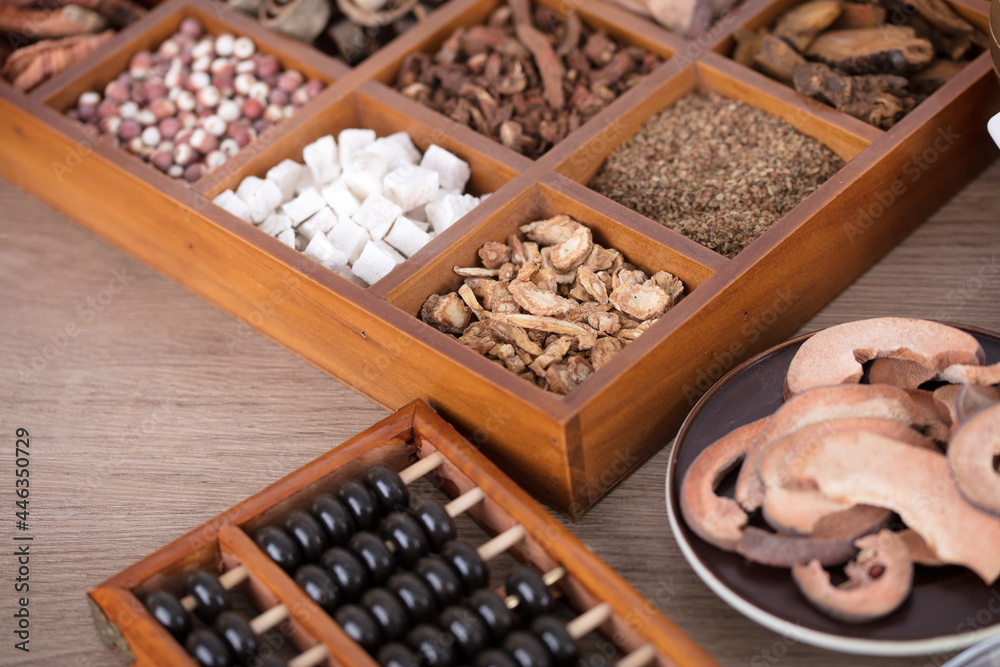 Different medicinal materials and abacus beads in a Chinese medicine medicine box