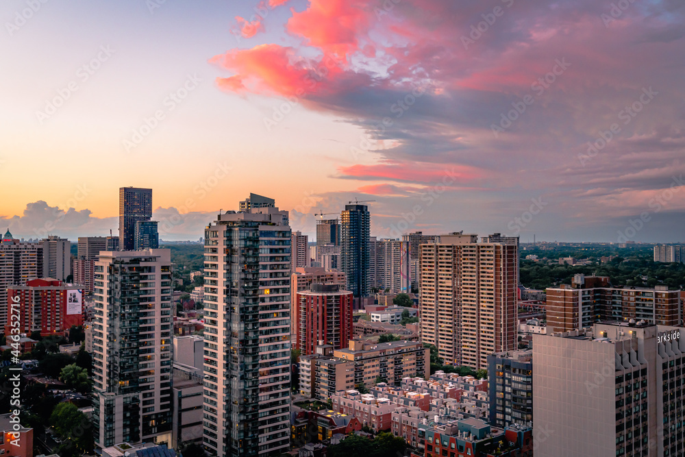 Beautiful colorful sunset Entire futuristic city skyline view of downtown Toronto Canada. Modern buildings, urban architecture, cars travelling. Construction and development in a busy city.