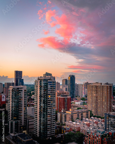 Beautiful colorful sunset Entire futuristic city skyline view of downtown Toronto Canada. Modern buildings, urban architecture, cars travelling. Construction and development in a busy city
