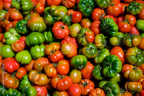 A pile of red and green heirloom tomatoes in a market in Martina Franca in the Puglia region of Italy.