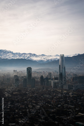 A view of Santiago, Chile, from the mountains, with the snowy mountains behind and the skyline