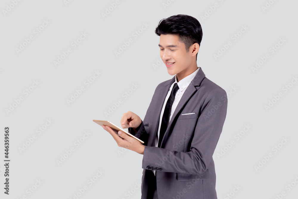 Portrait young asian business man in suit standing using tablet computer to internet isolated on white background, businessman confident touch screen digital pad with success, communication concept. Portrait young asian business man in suit standing using tablet computer to internet isolated on white background, businessman confident touch screen digital pad with success, communication concept.