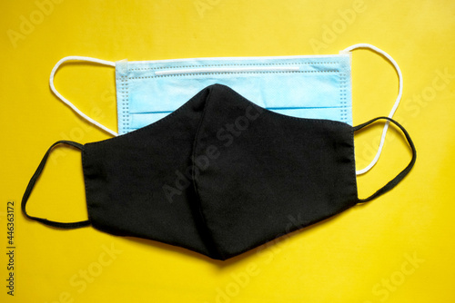 cloth and disposable face mask in yellow background