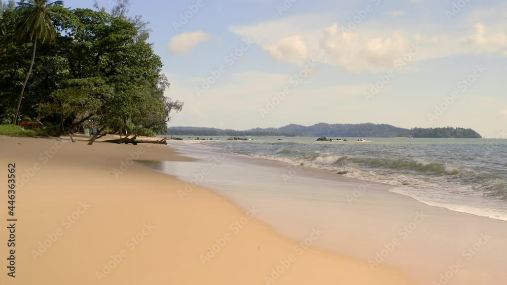 Beautiful dried tree root sticks out of sand on the tropical beach. Empty paradise sand beach. People travel vacations fun concept. Camera slowly moves near beautiful dead root and fly over the ocean. Beautiful dried tree root sticks out of sand on the tropical beach. Empty paradise sand beach. People travel vacations fun concept. Camera slowly moves near beautiful dead root and fly over the ocean.
