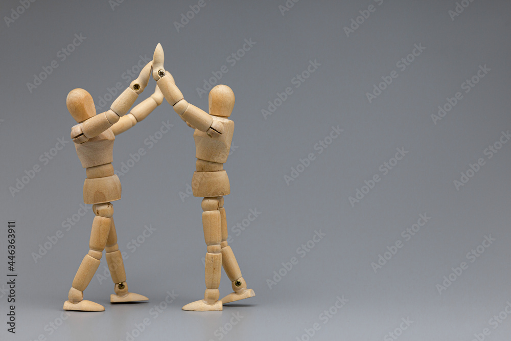 Wooden figure businessman pleasure and congratulate with team. Wooden figure businessman pleasure and congratulate with team.