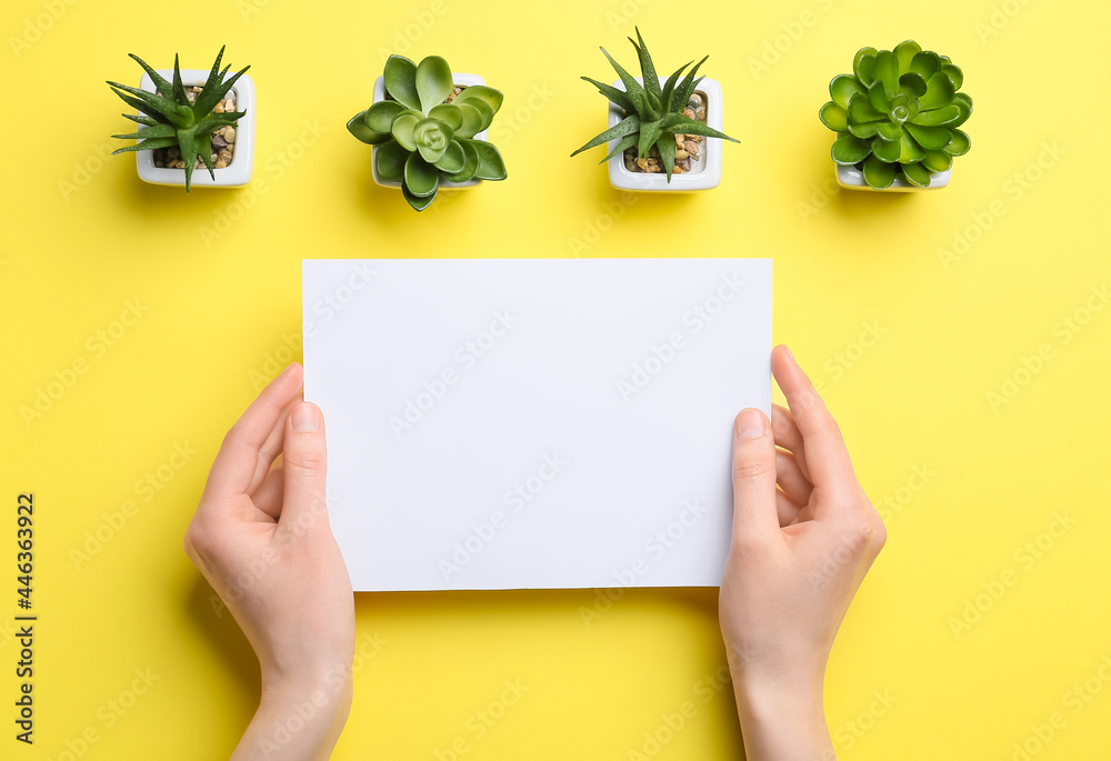 Female hands with blank sheet of paper and succulents on color background Female hands with blank sheet of paper and succulents on color background