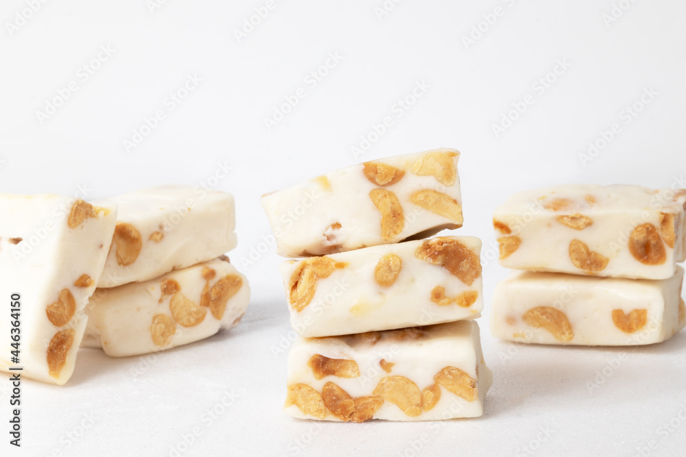 Traditional nougat with nut isolated on white background, close up.