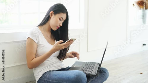 person using laptop and cell phone work shopping typing touch screen on smartphone typing on laptop keybroad photo